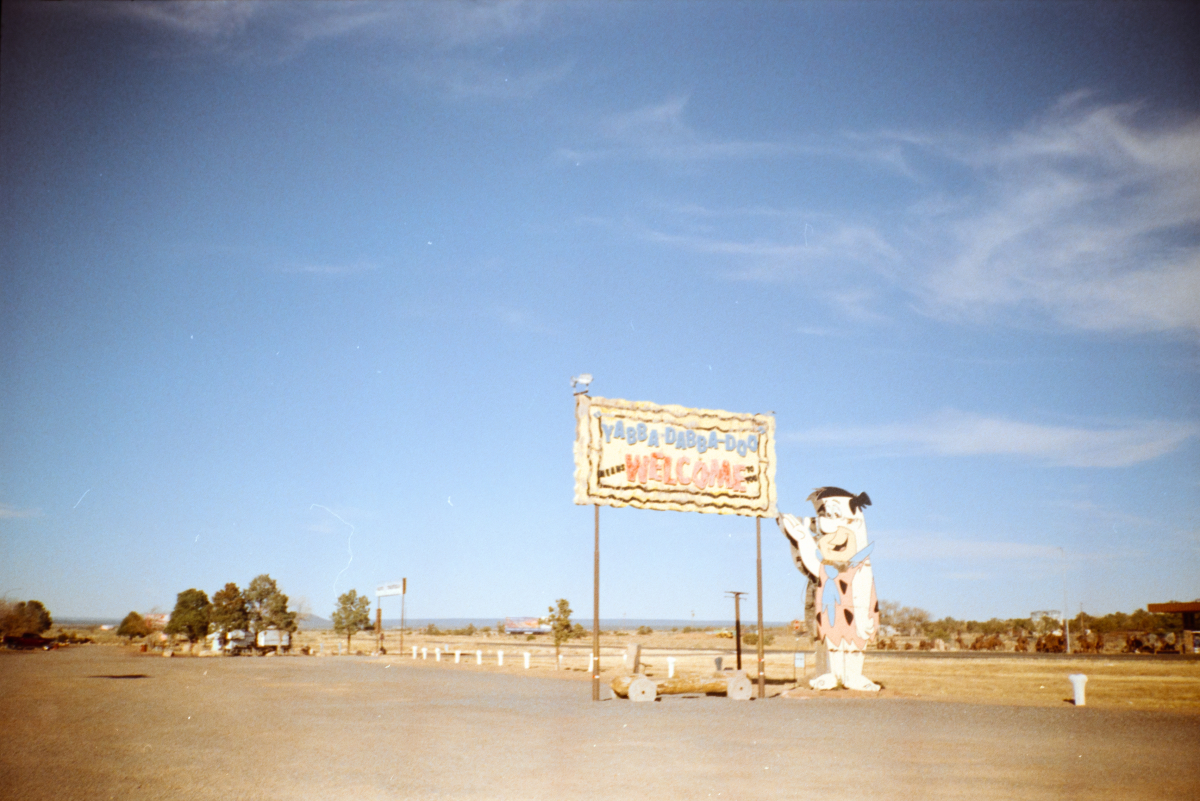 roadside sign for a flintstones themed attraction