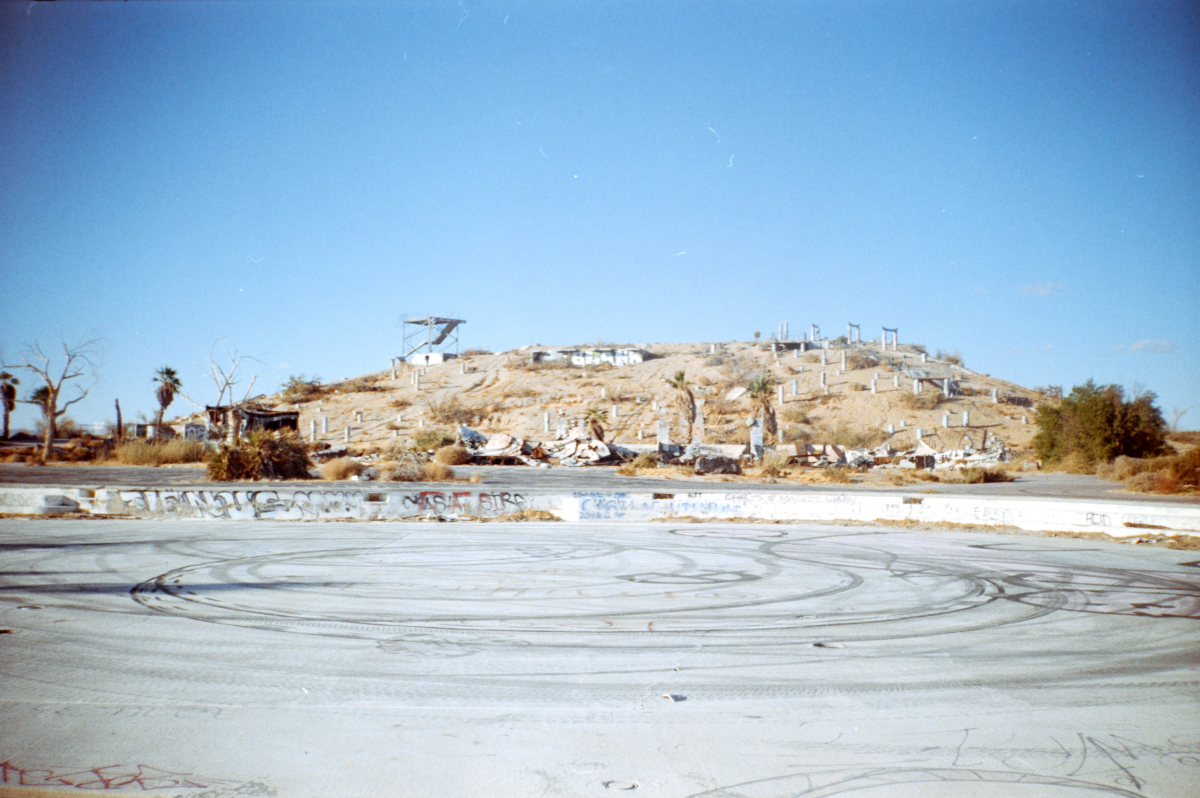 abandoned water park filled with tire tread marks on the asphalt