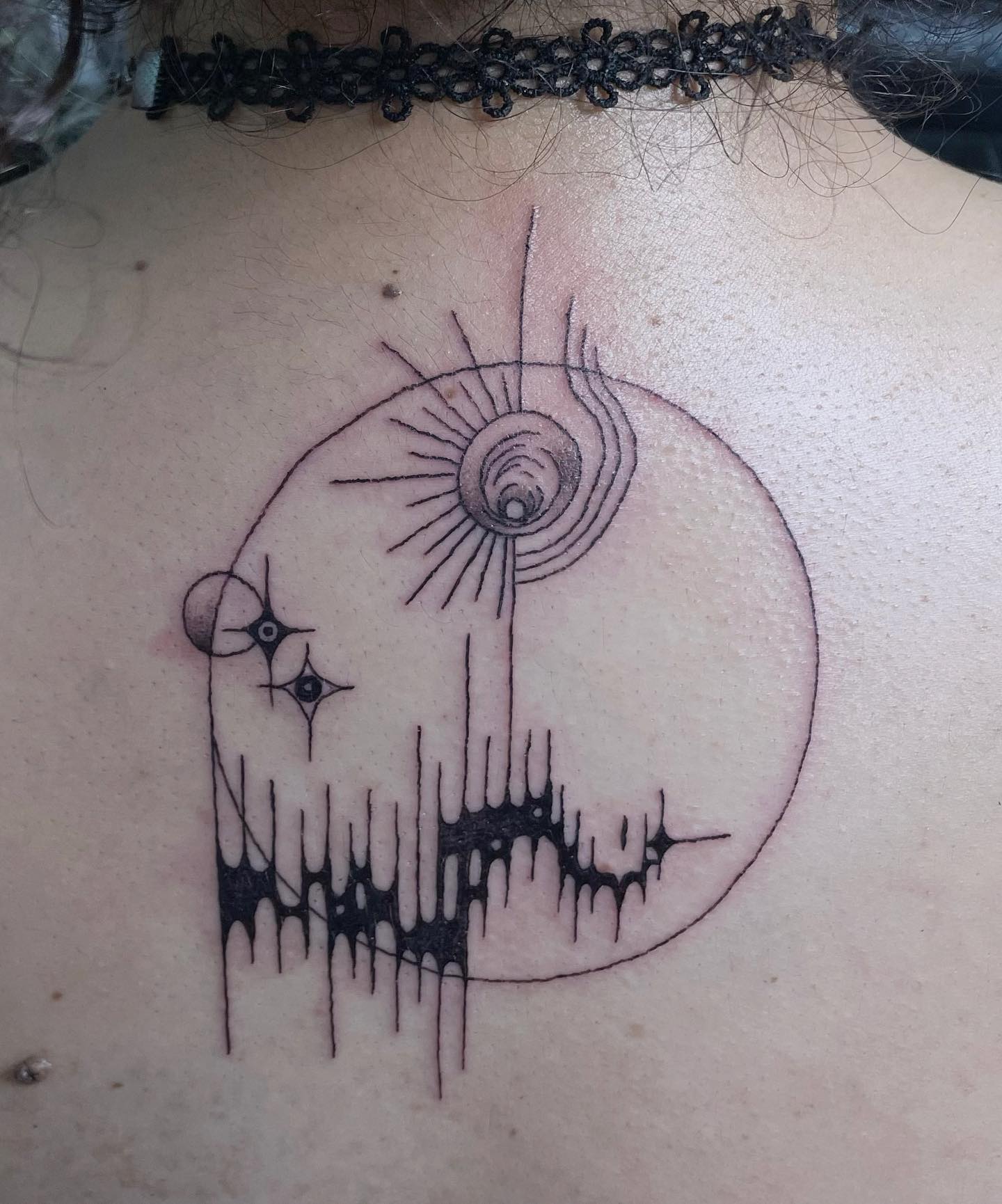 tattoo of an abstract circular design on a back