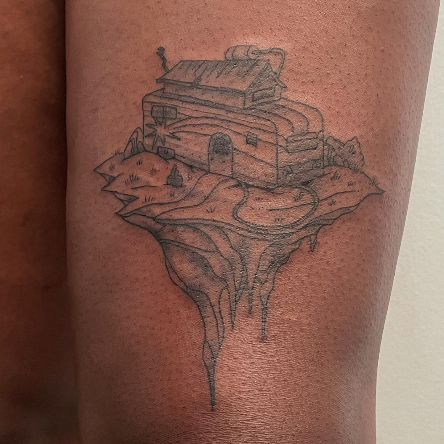 tattoo of a floating trailer on leg