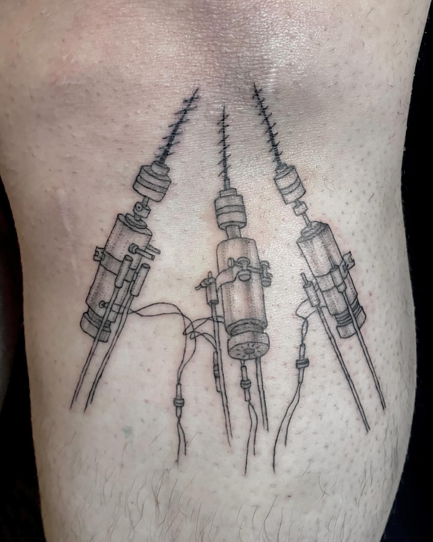 tattoo of three drills on leg