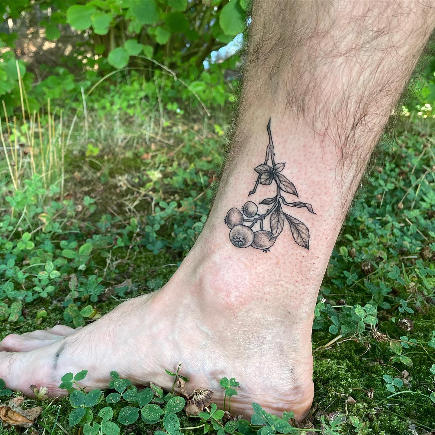 tattoo of blueberries on leg