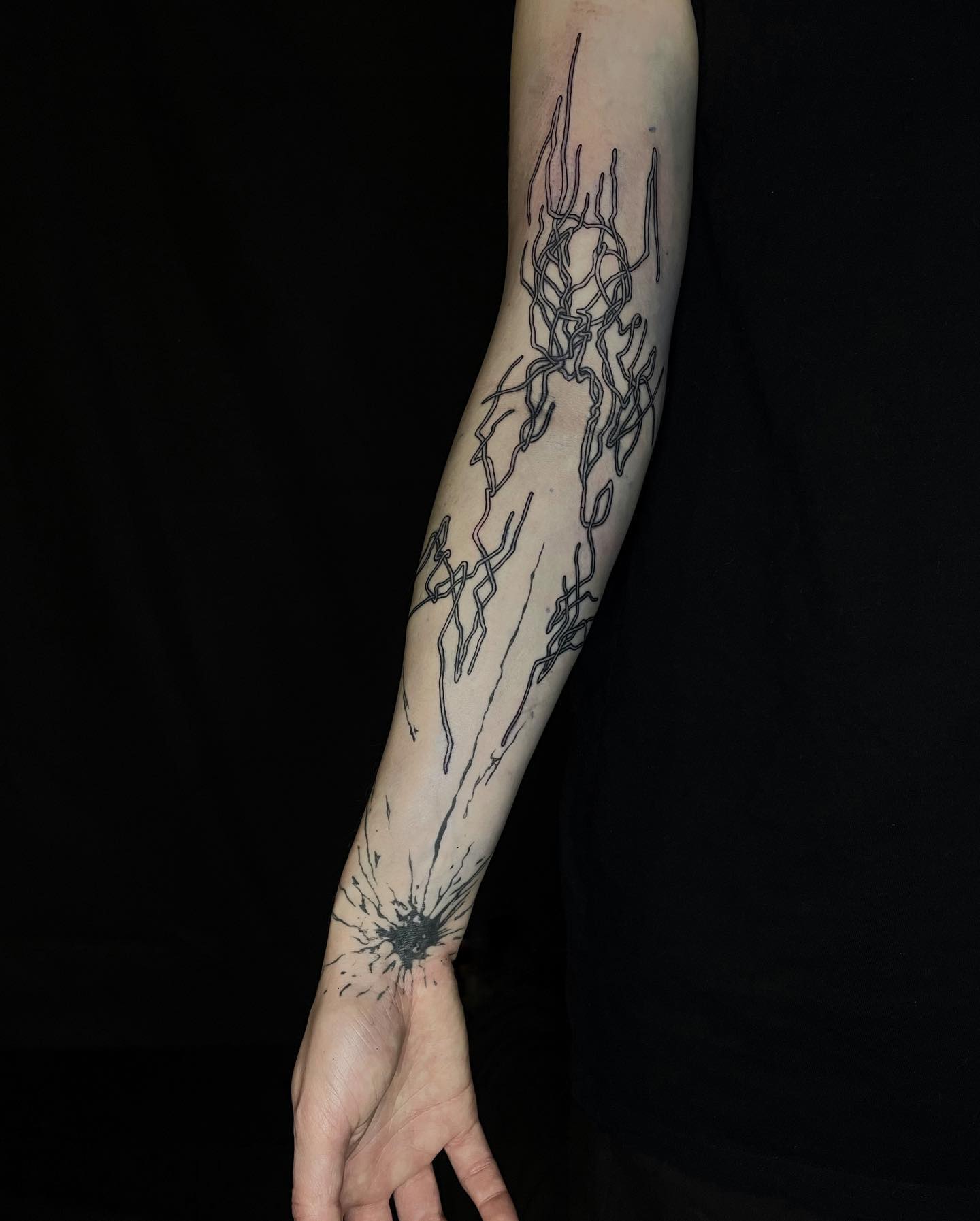 tattoo of wires on an arm