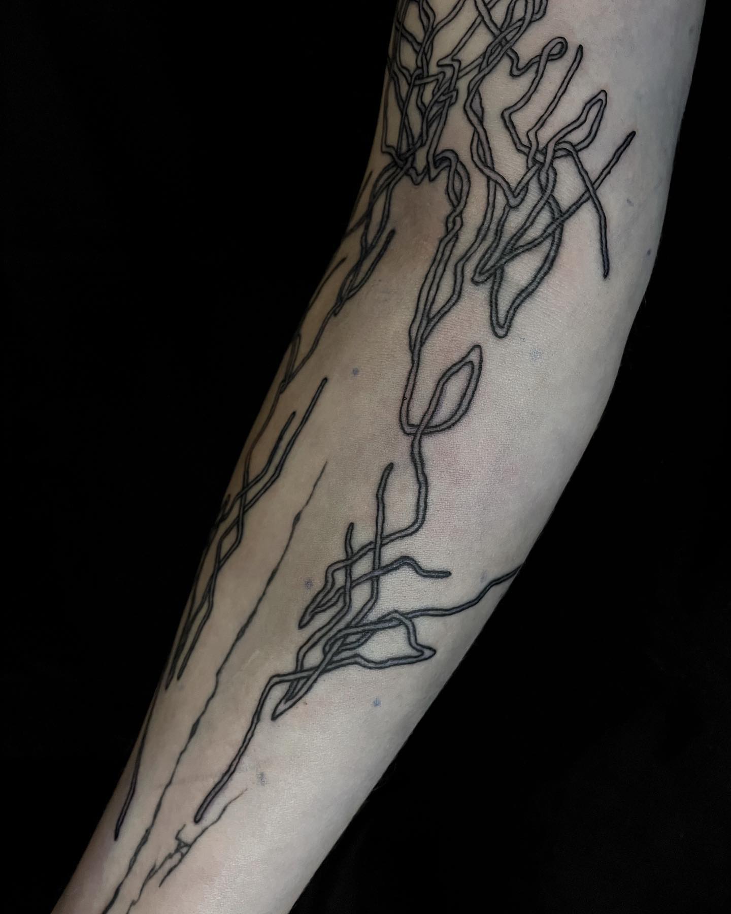 tattoo of wires on an arm