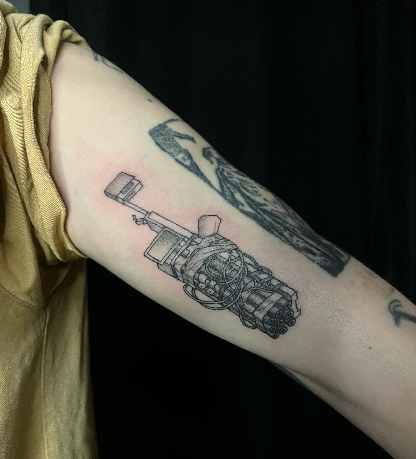 tattoo of a gun prototype on arm