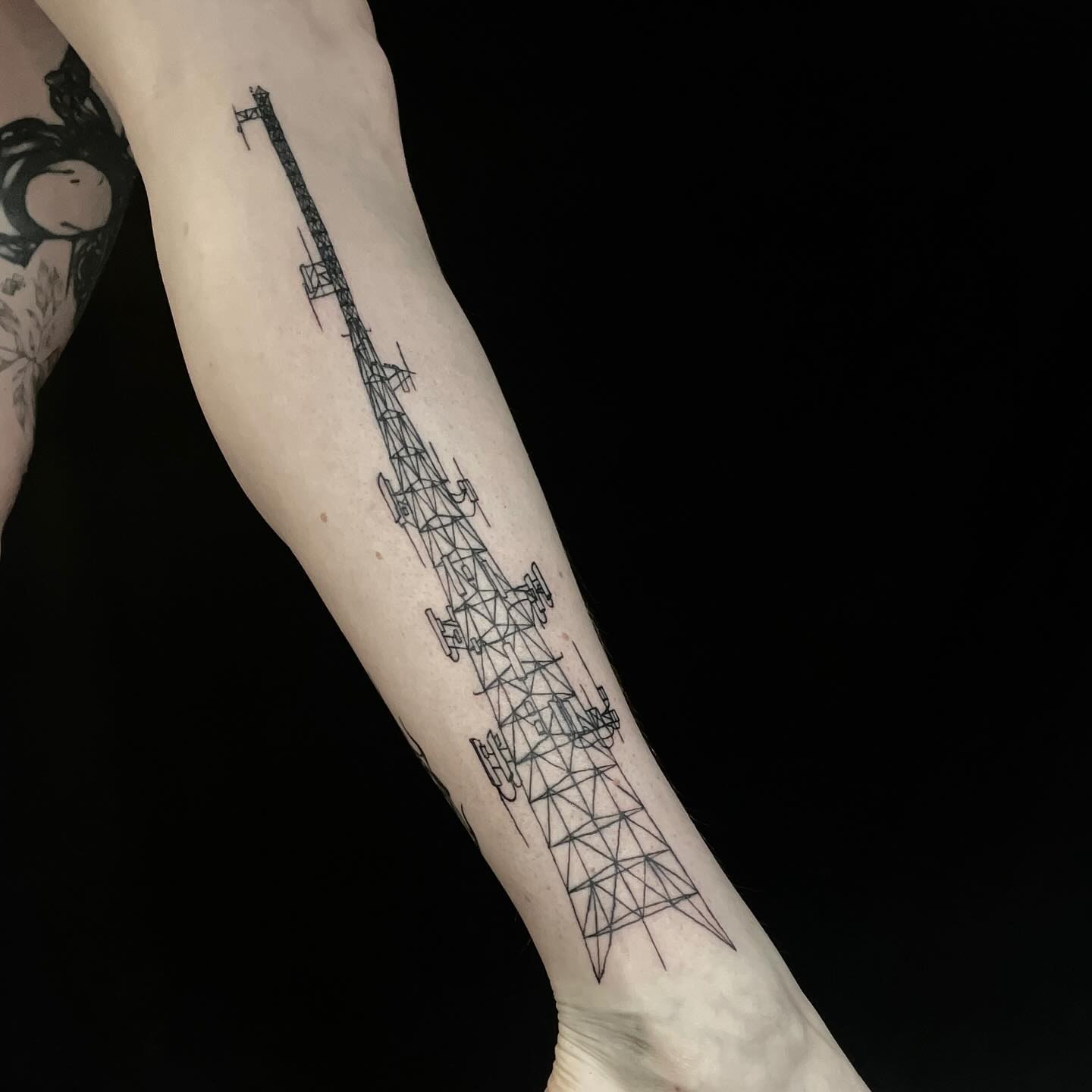 tattoo of a large radio tower on a leg