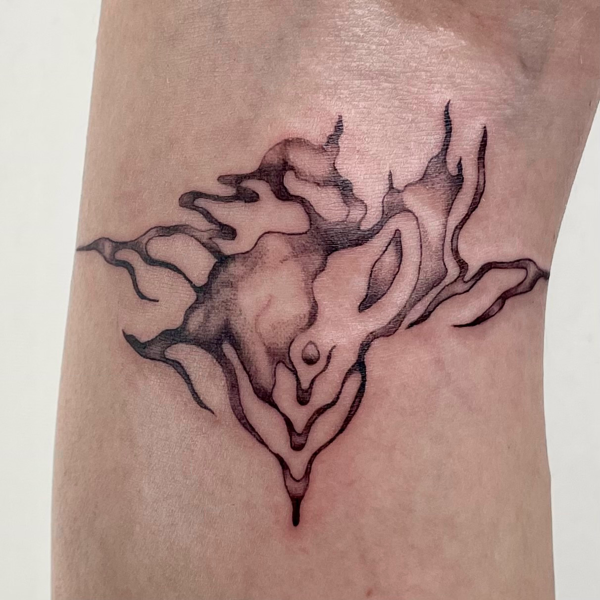 tattoo of an abstract and flowing drip castle tattoo