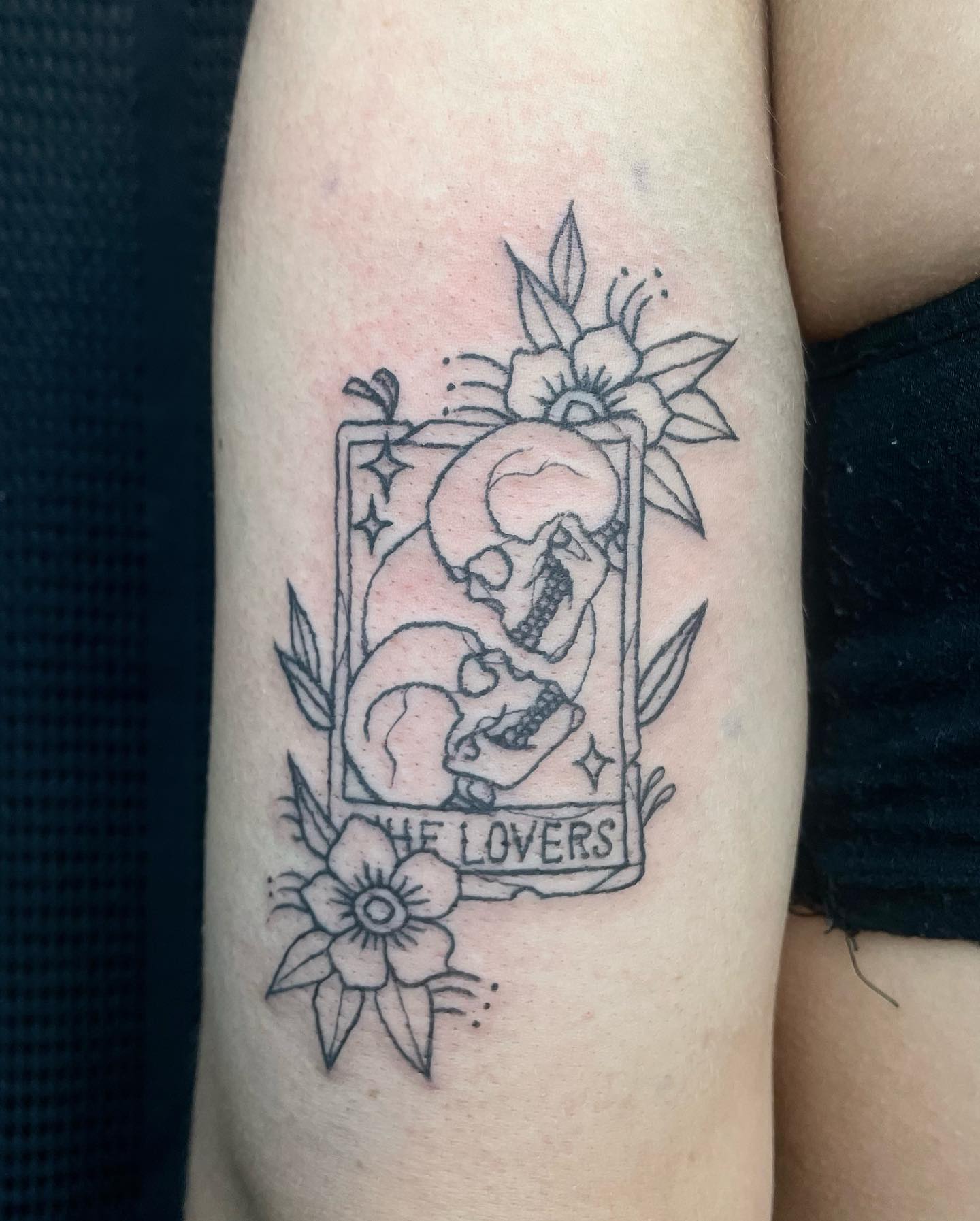 tattoo of the lovers tarot card with skeletons on arm