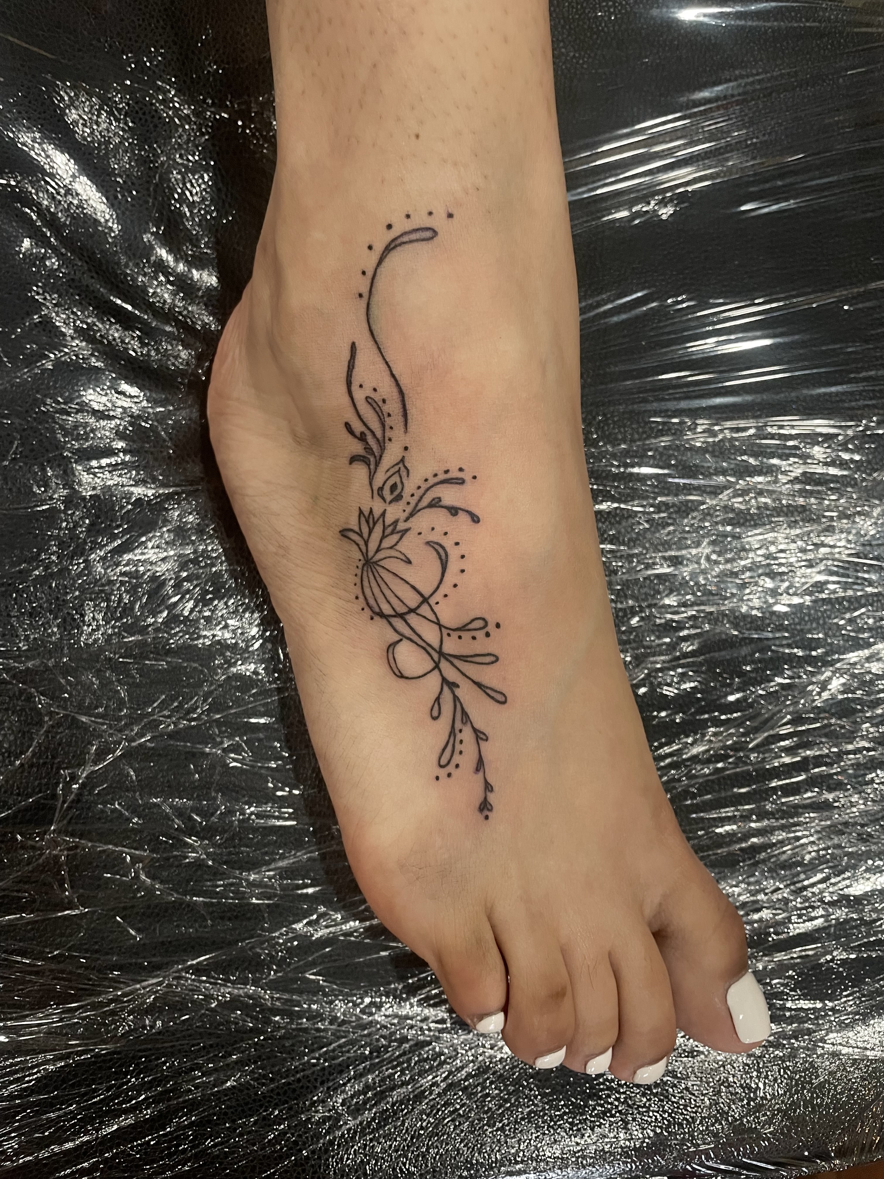 tattoo of an abstract y2k esque style foot tattoo